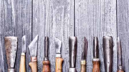 Set of handmade old knife on wooden background