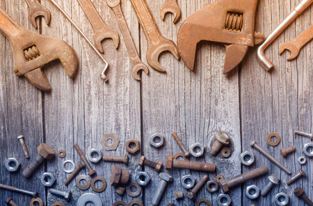 old photo of nuts , bolts and wrenchの写真素材