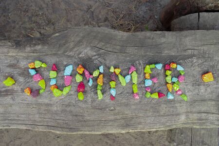 The photo of summer isolated word on wood bench for web background or summer invitation.の写真素材