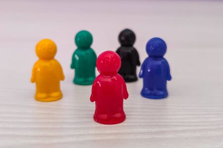 Conception  - game figures or pawns in a business situation. Colored chips of tabletop game in the little men formの写真素材