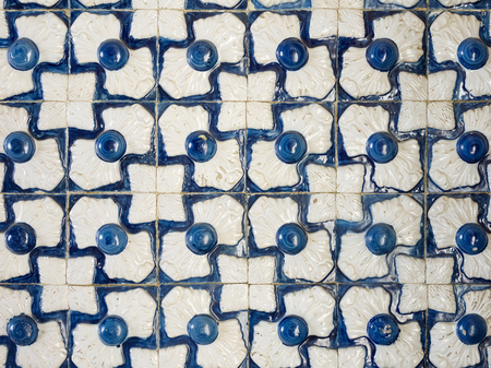 A piece of an old ceramic tile in Portugal on the walls of a house