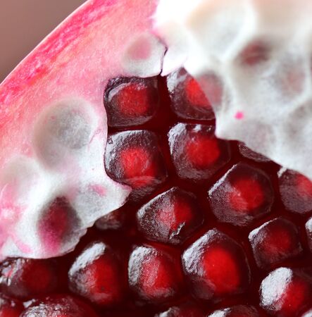 Grains of ripe juicy pomegranate macro photoの写真素材
