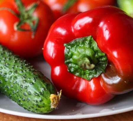 fresh vegetables on a white plate macro photoの写真素材
