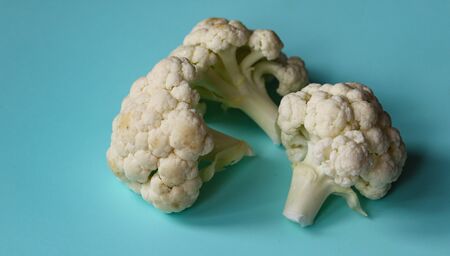 pieces of cauliflower on a blue background close upの写真素材