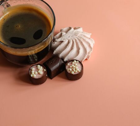 a ?up of coffee and sweets on a pink background close upの写真素材