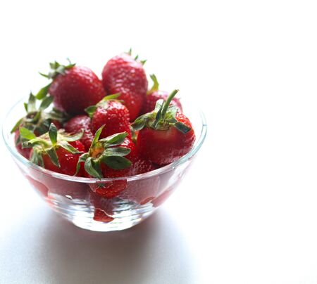 ripe sweet strawberries in a glass bowl close upの写真素材