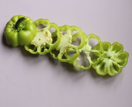 sliced green pepper on a light background close upの写真素材