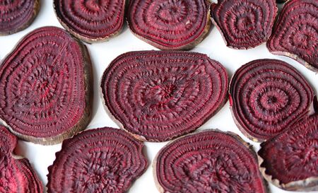 baked slices of red beetroot on a white plate close upの写真素材
