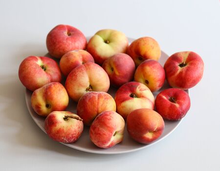 ripe juicy peaches on a white background close upの写真素材
