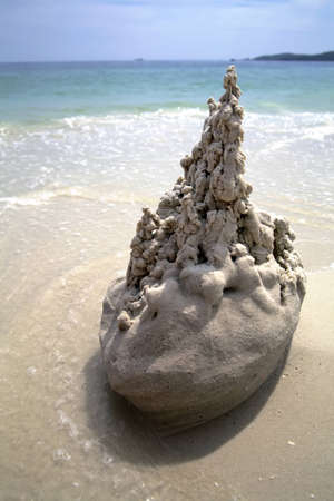 sand castle on the beach close to the seaの写真素材