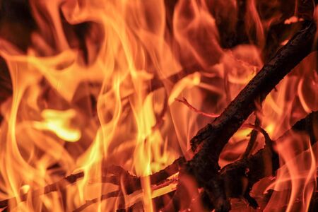 Night bonfire close-up.  Soft overflows of flame. Soft red and orange tones.の写真素材