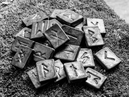 24 Norse runes on grass in black and white background.の写真素材