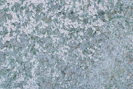 Old broken chipboard with green paint residues. Background texture. Macro.の写真素材