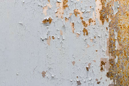 Background. Old gray metal wall with weathered paint, scratches and rust.の写真素材