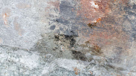 Background. Old gray metal wall with weathered paint, scratches and rust.の写真素材