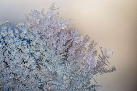 Abstract, graphic, natural background. Ice patterns on the glass of the window. Macro. Christmas...