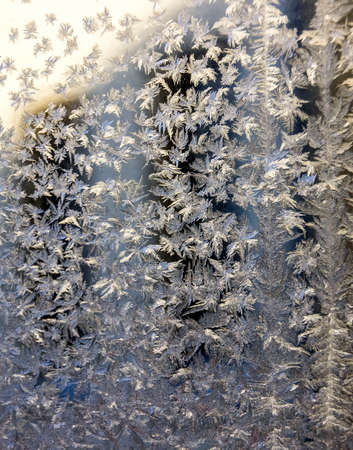 The texture of the glass covered with frost in winter in cold weather. Abstract natural background.
