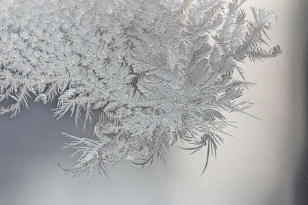 Abstract, graphic, natural background. Ice patterns on the glass of the window. Christmas holidays.の写真素材