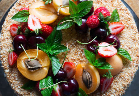 Cake with cream cheese, fresh berries, fruits and green mint. view from above.の写真素材