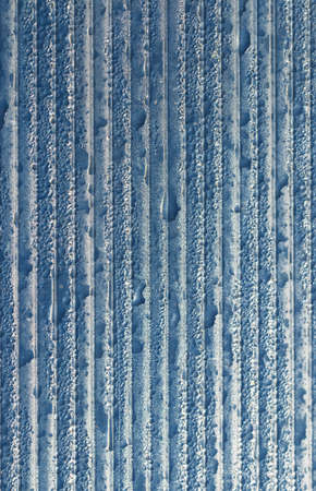 Texture of striped polycarbonate with water drops against the blue sky. Abstract background. Close-up.の写真素材