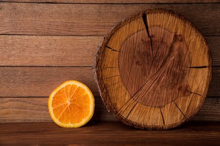 Orange on a wooden table. Cut orange on wooden boards.の写真素材