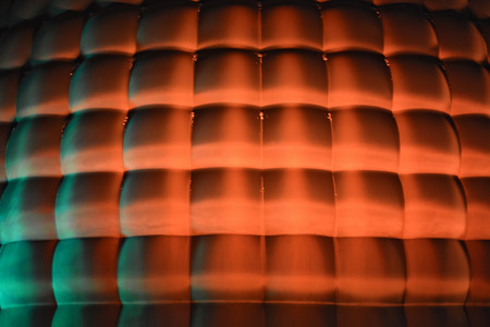The facade of the volume of cubes with orange mood lighting. Illuminated decoration of modern facade...
