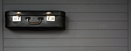 Black vintage suitcases on the wooden grey background. Retro travel luggage. Space for  design. Top view. Concept: tourism, travel and migrationの写真素材
