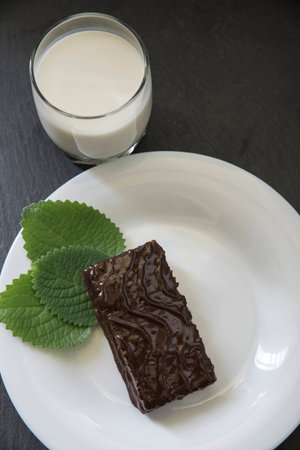 chocolate cake and mint leaf on plateの写真素材