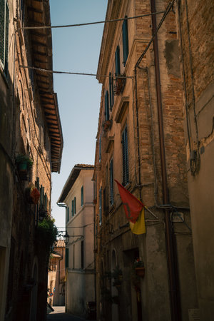 village street scene, sunlit alley with hanging wires, busy village alley with tall buildings and wiresの写真素材