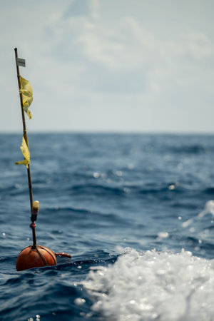 maritime marker amidst turbulent waters, research and navigation marker amid choppy deep blue ocean wavesの写真素材