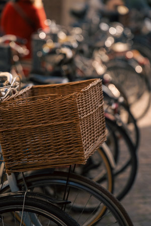 historic city scene showcasing vintage bicycle with handcrafted wicker basket in morning sunlightの写真素材