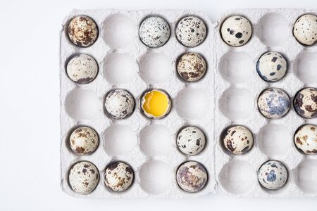 cardboard box with quail eggs on a white tableの写真素材