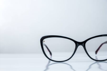 hipster fashion black glasses on white tableの写真素材