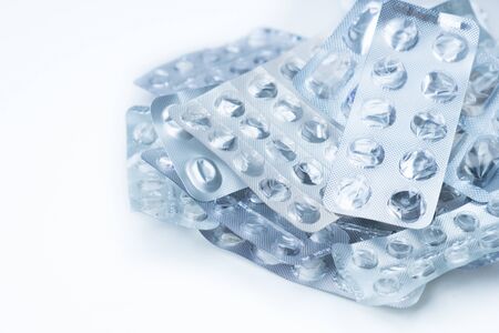 empty plastic blister packs of pills are piled in a pileの写真素材
