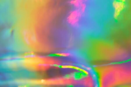 abstract holographic iridescent foil texture background with rainbow colored spotsの写真素材
