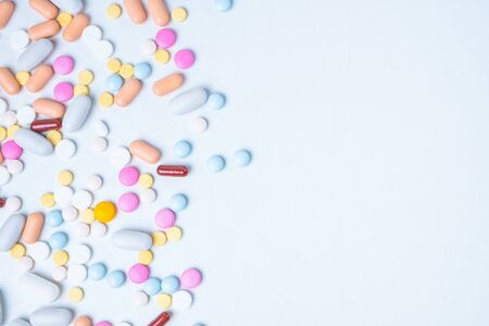 colored pills on white background with copy space for textの写真素材