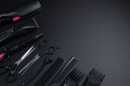 tools for haircuts and hair styling on a black backgroundの写真素材