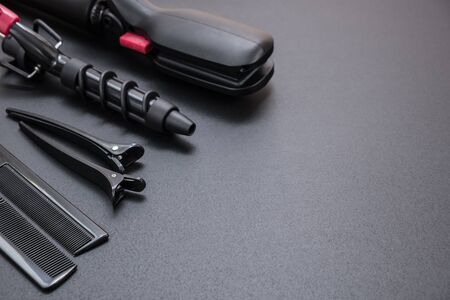 tools for haircuts and hair styling on a black backgroundの写真素材