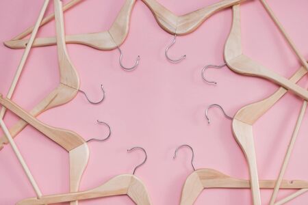 wooden empty clothes hangers on a pink background. concept: pop modern saleの写真素材
