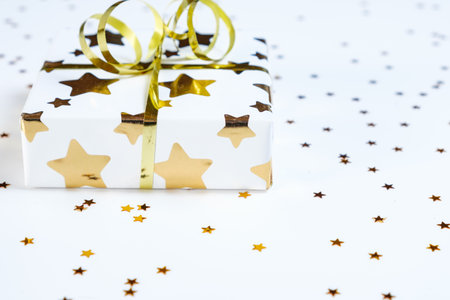 a layout of New Year or Christmas gifts surrounded by foil candy and Christmas tree decorations