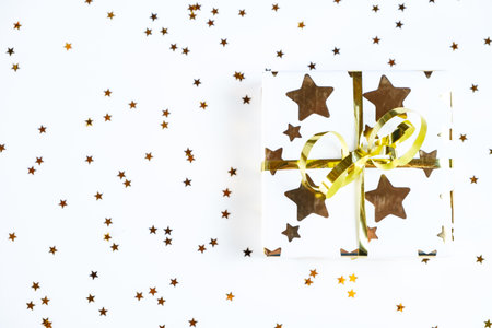 a layout of New Year or Christmas gifts surrounded by foil candy and Christmas tree decorationsの写真素材