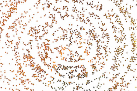 christmas or new year background of gold foil confetti scattered on a white tableの写真素材