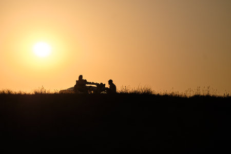 Gradient sky in sunset light on a hot summer evening. Contours in backlit sunlight. Golden hour.の写真素材