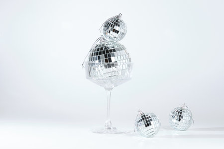 Composition of disco balls in glass on white backgroundの写真素材