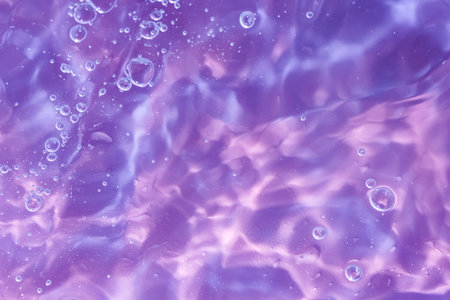 Abstract background. The texture of the waves on a blue background. Bubbling water, splashes and drops.の写真素材