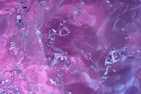 Abstract background. The texture of the waves on a blue background. Bubbling water, splashes and drops.の写真素材