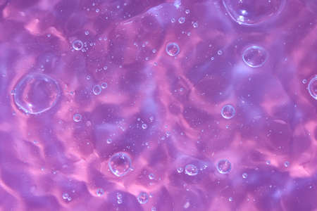 Abstract background. The texture of the waves on a blue background. Bubbling water, splashes and drops.の写真素材