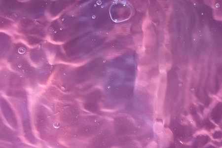 Abstract background. The texture of the waves on a blue background. Bubbling water, splashes and drops.の写真素材