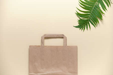 Paper eco bag for shopping on a beige background. The concept of minimizing consumption, zero waste, reducing the amount of non-degradable waste.の写真素材