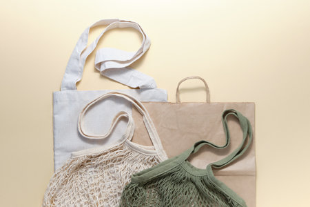 Eco-friendly shopping bags and paper bags on a beige background. The concept of minimizing consumption, zero waste, reducing the amount of non-degradable waste.の写真素材